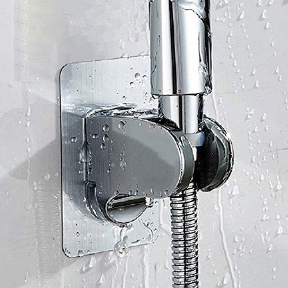 Support de douchette adhésif fixé au mur d'une salle de bains