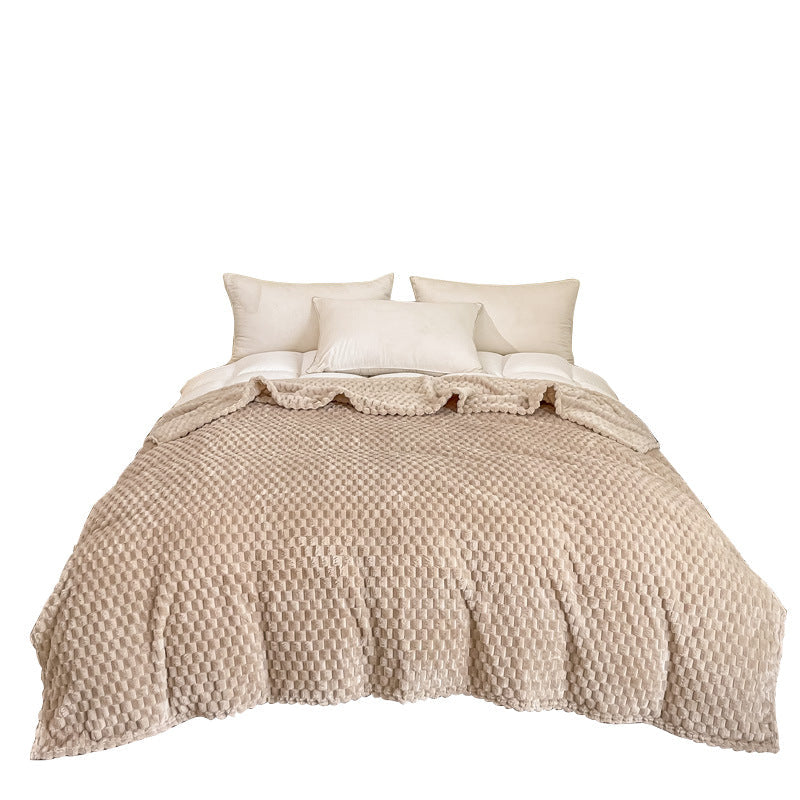Plaid texturé étalé sur le pied d'un lit