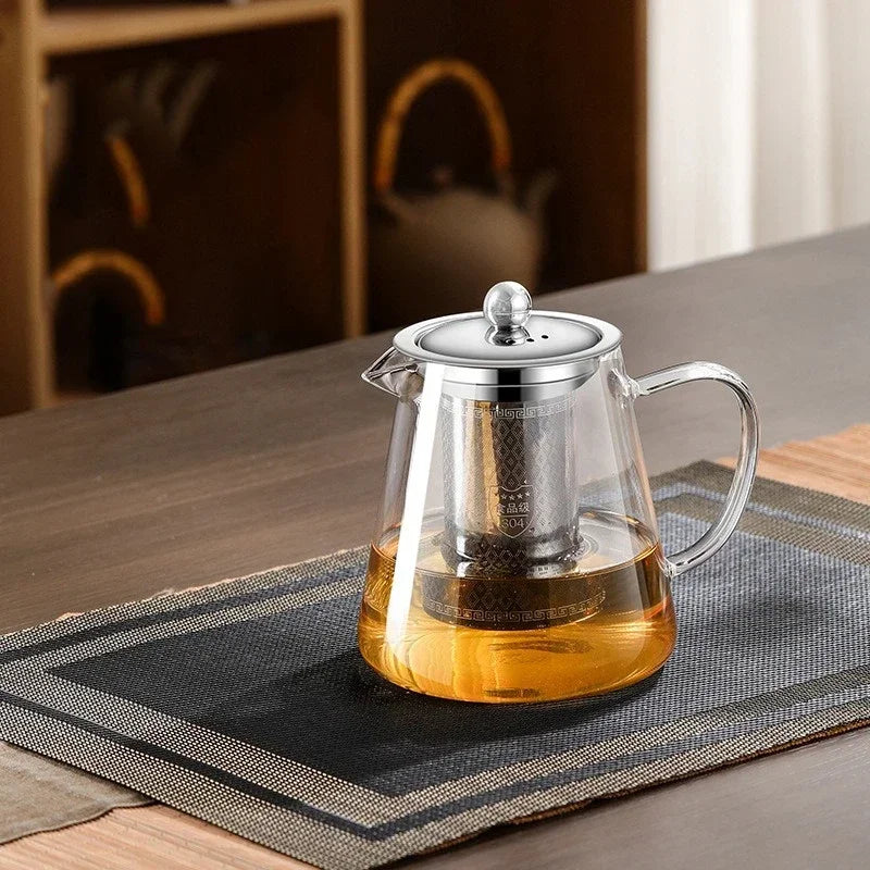 Théière en verre borosilicate avec filtre en acier inoxydable, posée sur une table