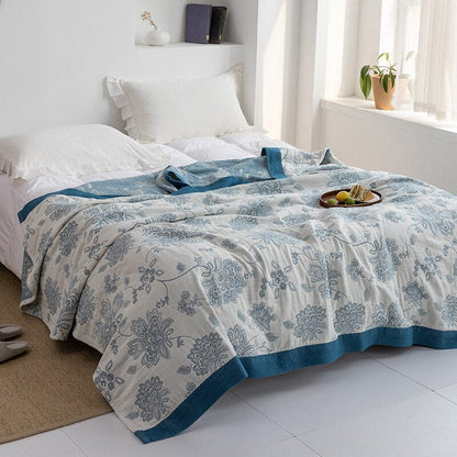Plaid japonais en coton, motif fleuri blanc et bleu, posé sur un lit.
