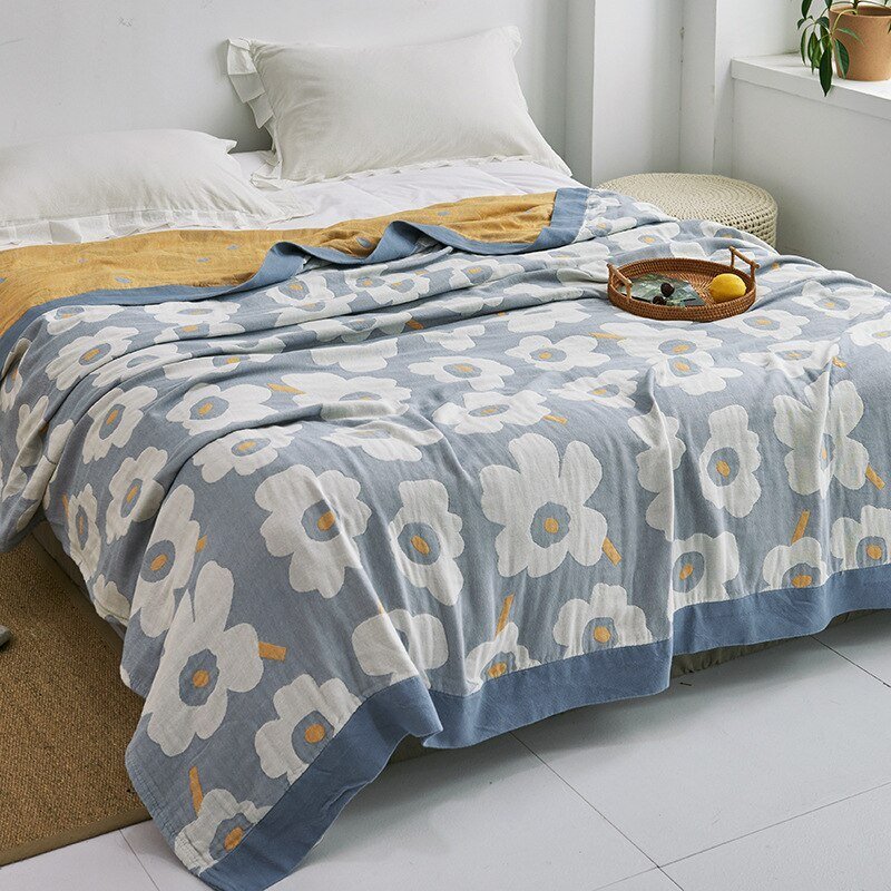 Plaid japonais en coton, motif fleurs bleu et blanc, posé sur un lit.
